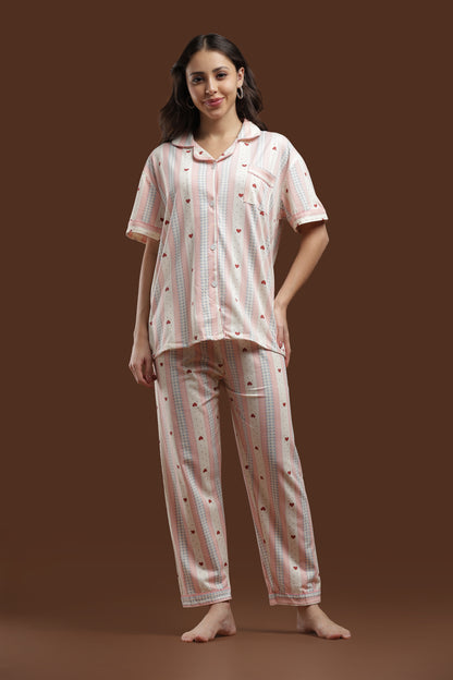 Koozy pajama set in a pink heart print. A Pinterest-style cotton, breathable fabric nightwear suite designed for a soft, easy, and cozy look. Cute and comfortable PJ set for lounging 
