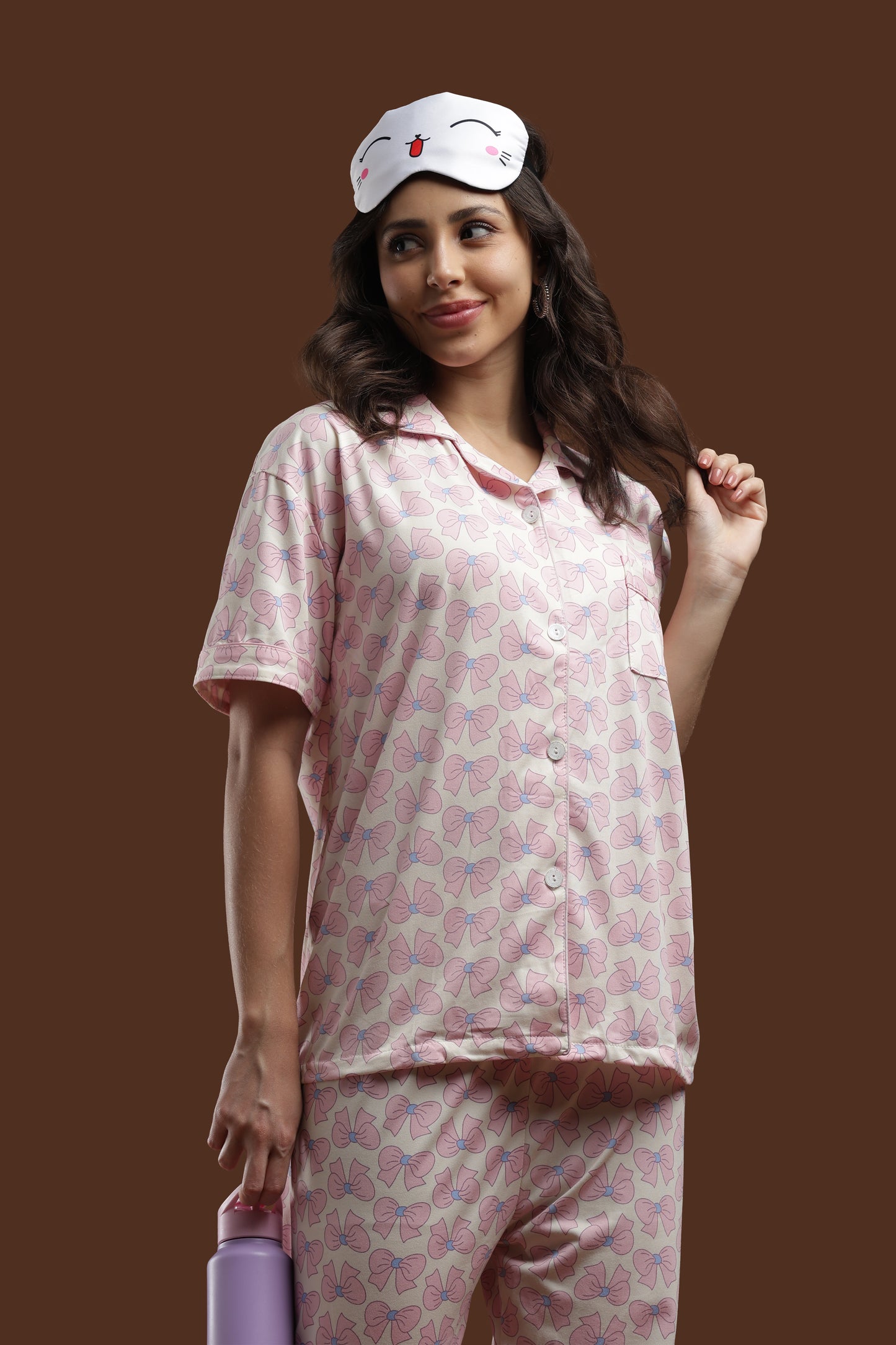 a complete view of the koozy pink ribbon print pajama set. this off-white, pinterest-style cotton nightwear suite features cute pink bow print details, short sleeves, and a comfortable, relaxed fit.