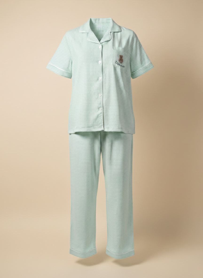 Ghost mannequin shot of the Koozy light mint green checkered pajama set, showcasing the structured fit of the button-down short-sleeve shirt and matching long pants. This Pinterest-style cotton nightwear suite highlights the breathable fabric and relaxed silhouette for a soft, easy, and cozy look.