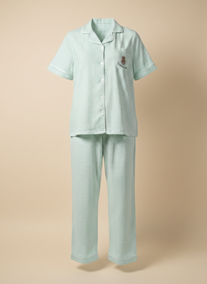Ghost mannequin shot of the Koozy light mint green checkered pajama set, showcasing the structured fit of the button-down short-sleeve shirt and matching long pants. This Pinterest-style cotton nightwear suite highlights the breathable fabric and relaxed silhouette for a soft, easy, and cozy look.