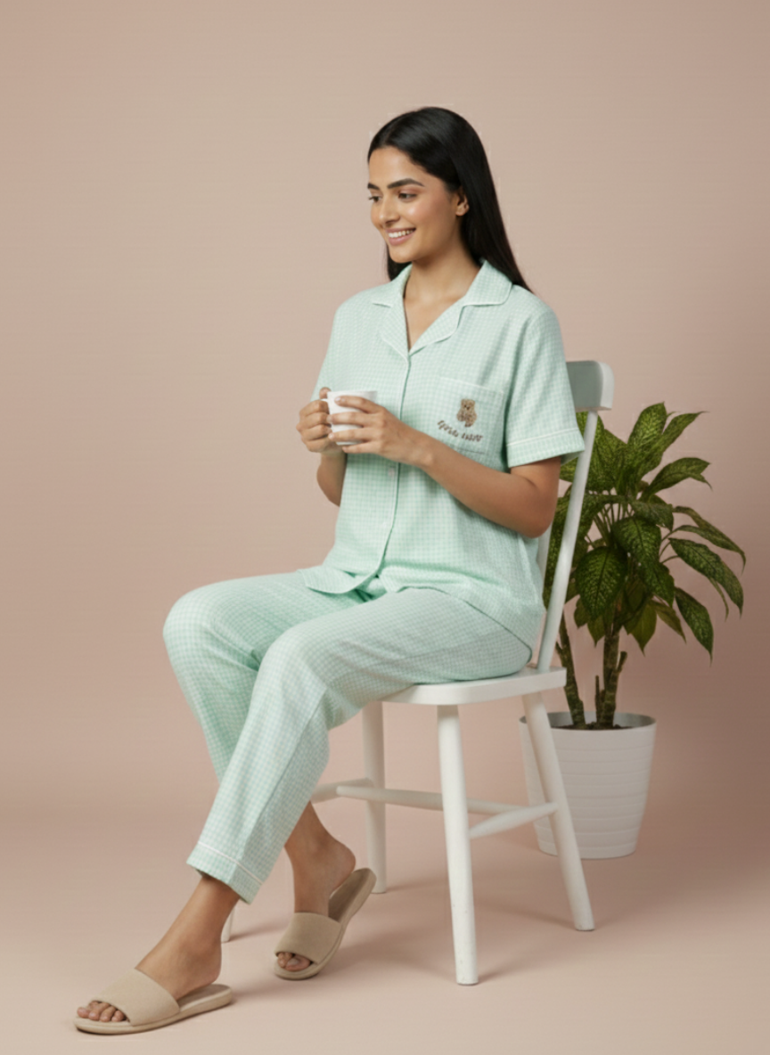 detailed view of the light mint green and white check pattern on the koozy pajama pants. emphasizing the high-quality, breathable cotton material and clean, comfortable finish of this nightwear suite.